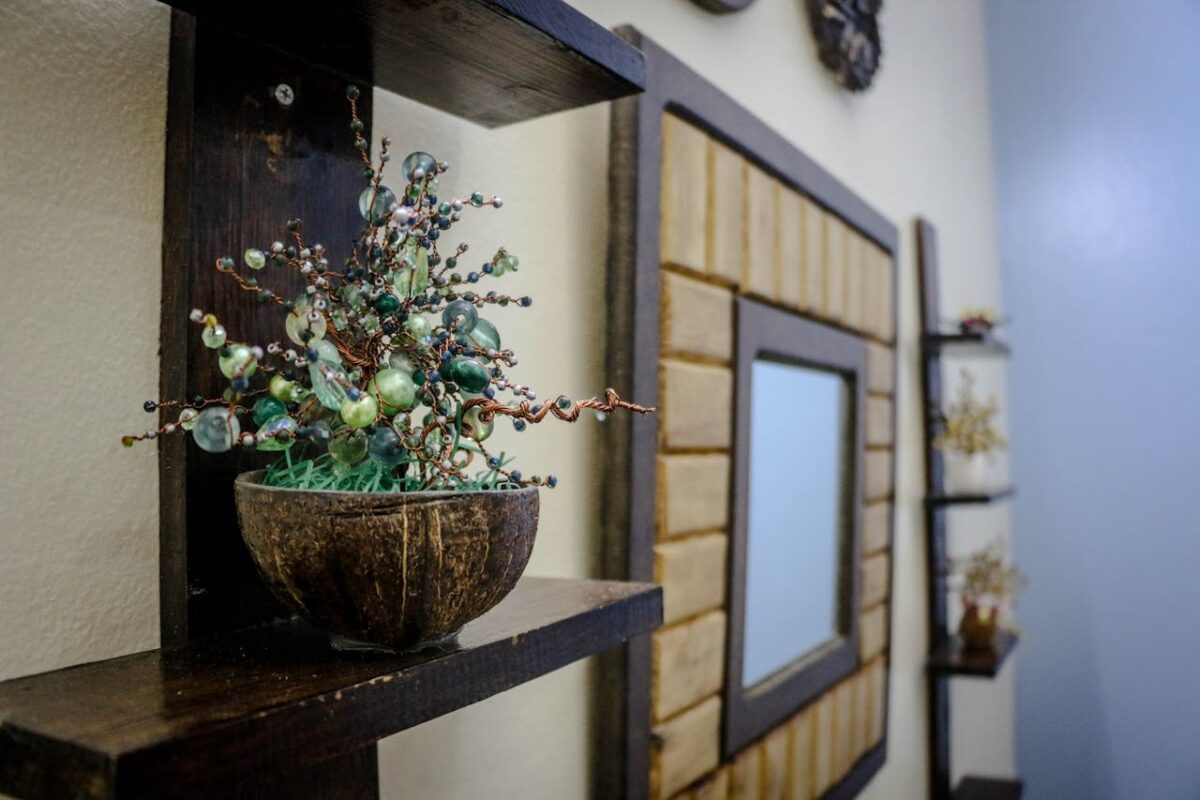 Artistic handmade bead decoration in a wooden bowl on a shelf, adding a creative touch to home decor.